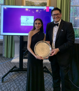 Dr. Alp Sener presents an award, a silver plate, to the winner of the Harvey Prize